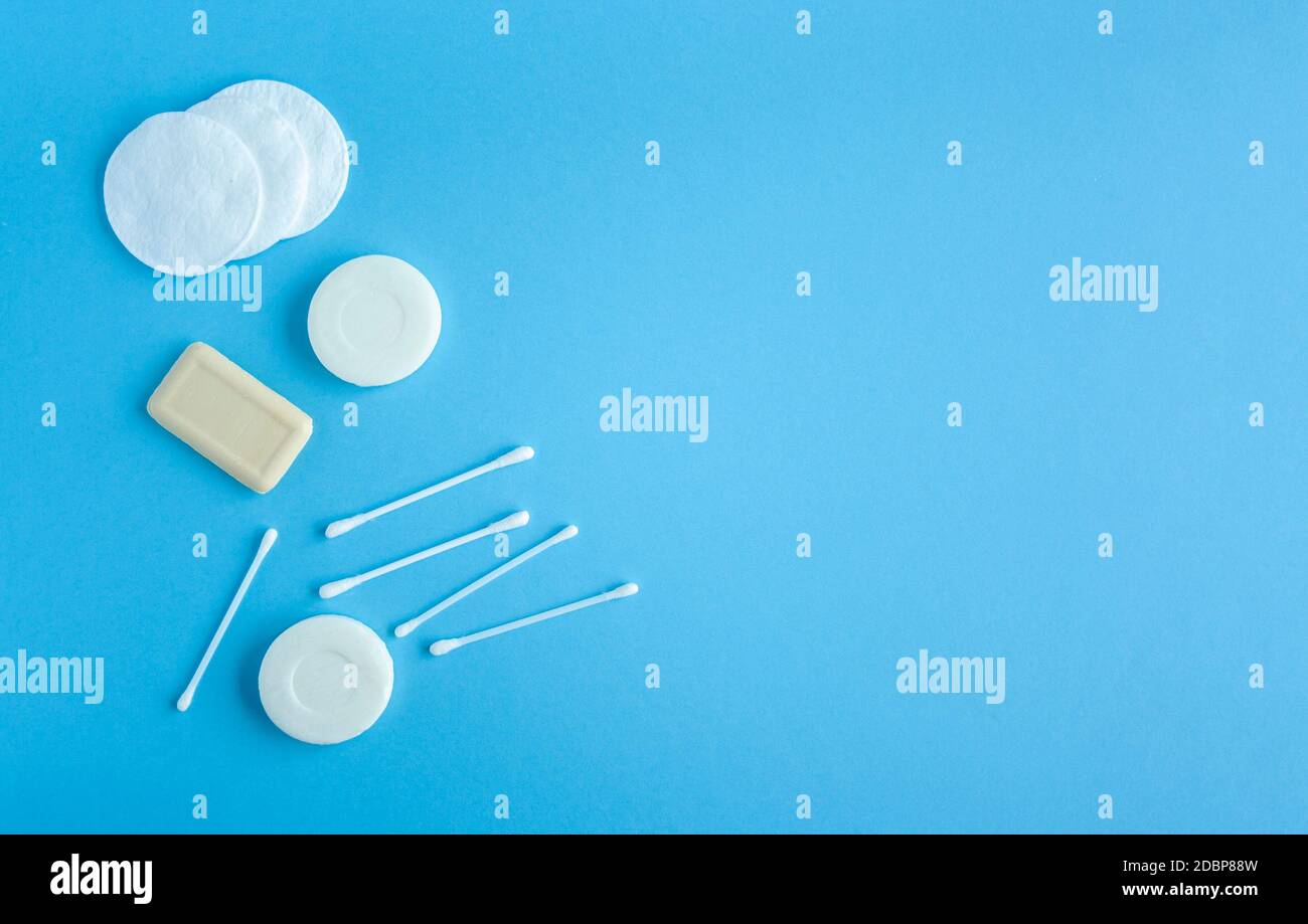 Composition of soap, cotton swabs and cotton pads top view. Self