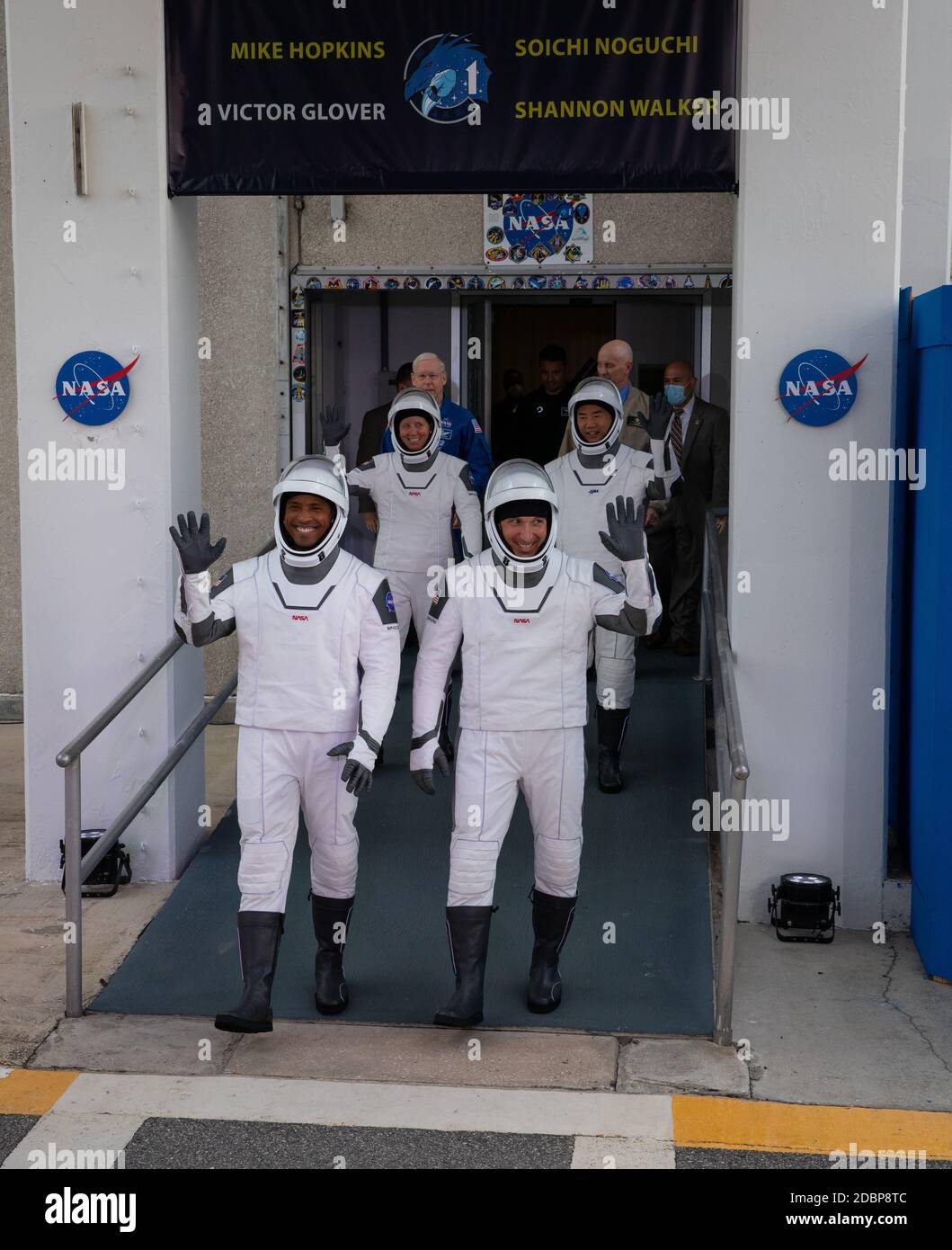The NASA SpaceX Commercial Crew One astronauts wave as they depart the Neil  Armstrong Operations and Checkout Building for liftoff at the Kennedy Space Center November 15, 2020 in Cape Canaveral, Florida. Standing left to right are: Front row: NASA astronaut Victor Glover and Mike Hopkins; back row: NASA astronaut Shannon Walker and JAXA astronaut Soichi Noguchi all wearing SpaceX ACES launch suits. Stock Photo