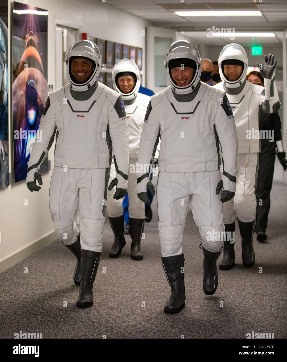 The NASA SpaceX Commercial Crew One astronauts walk down the hallway of the Neil  Armstrong Operations and Checkout Building at the Kennedy Space Center November 15, 2020 in Cape Canaveral, Florida. Standing left to right are: Front row: NASA astronaut Victor Glover and Mike Hopkins; back row: NASA astronaut Shannon Walker and JAXA astronaut Soichi Noguchi all wearing SpaceX ACES launch suits. Stock Photo