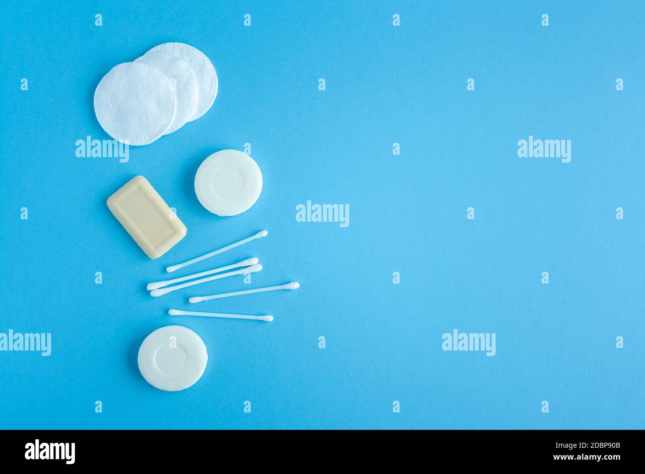 Composition of soap, cotton swabs and cotton pads top view. Self