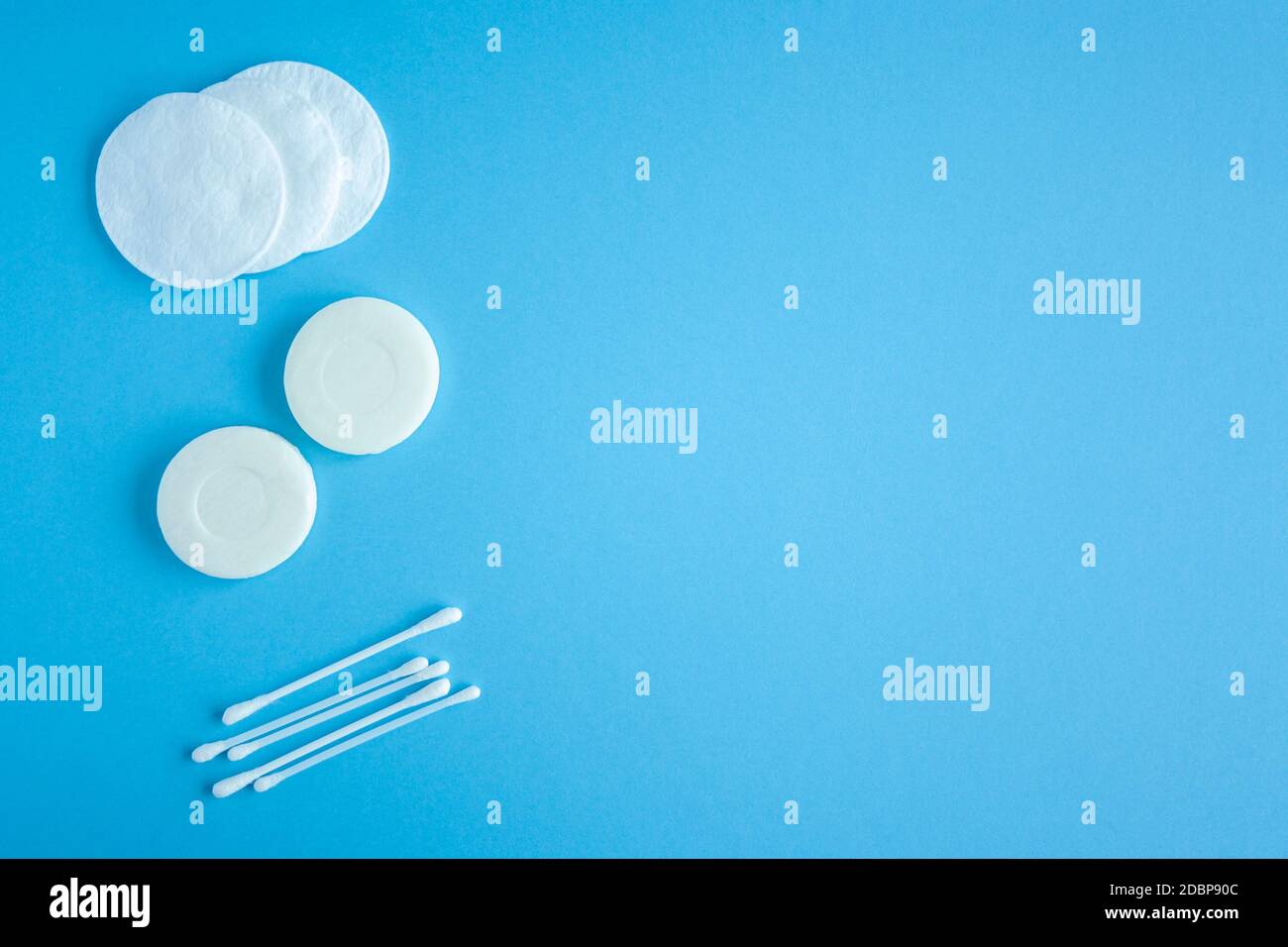 Composition of soap, cotton swabs and cotton pads top view. Self