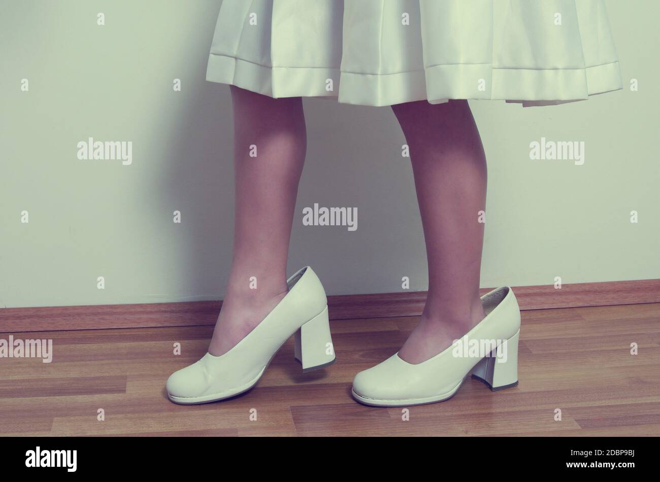 small girl with big adult shoes Stock Photo