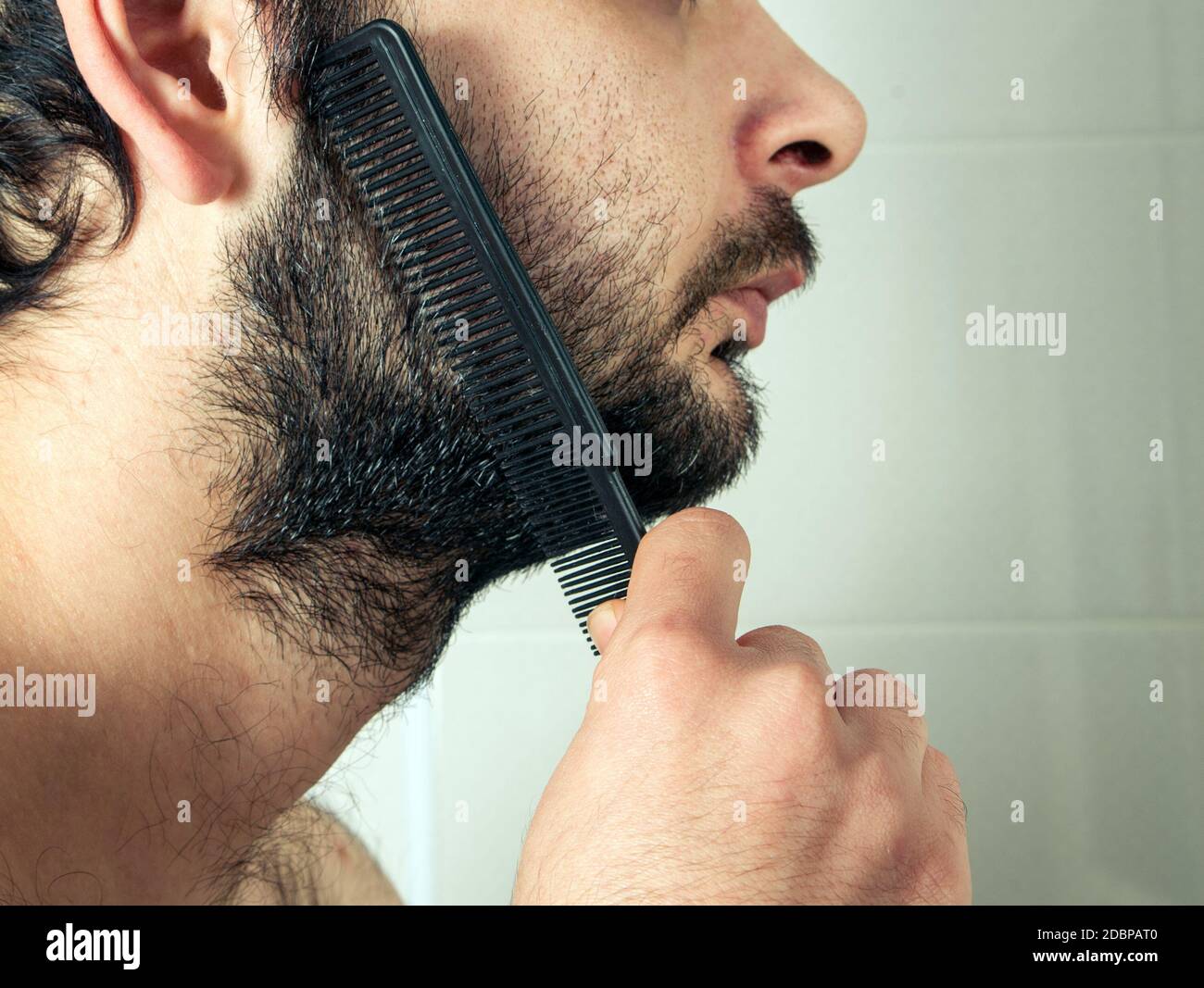 man combing beard hair closeup Stock Photo Alamy
