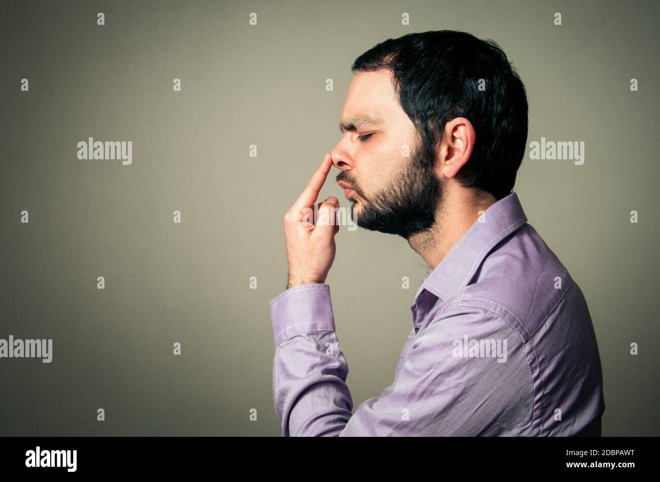 man with beard touching his nose Stock Photo