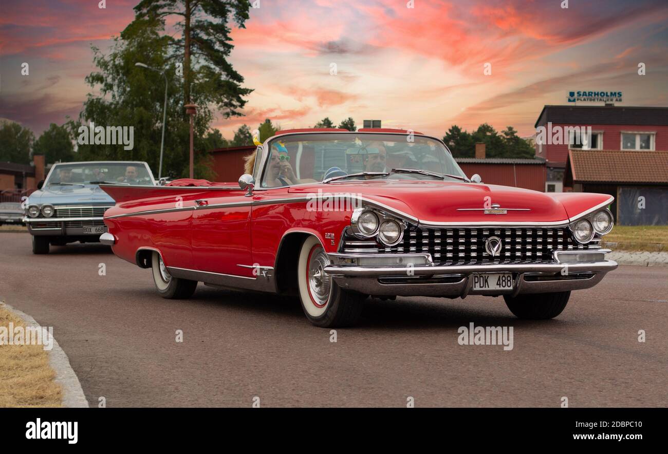 Rattvik, Sweden - July 27, 2013: Classic Car Week Rättvik - Buick Electra 225 Convertible oldtimer car. Old red convertible - vintage car, sunset. Stock Photo