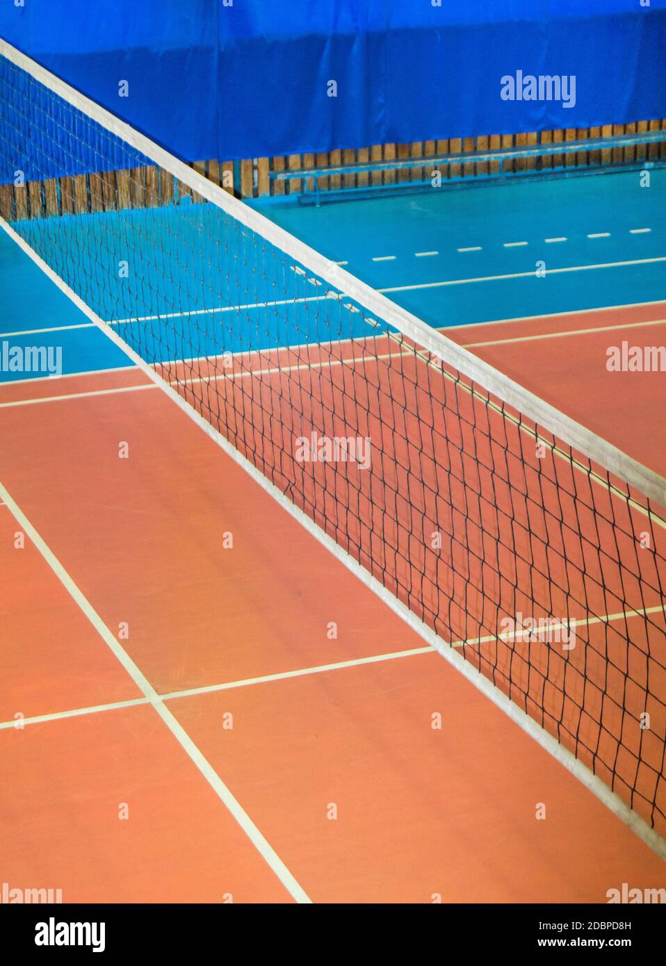 Modern empty school gym indoor with volleyball net, vertical frame. Stock Photo