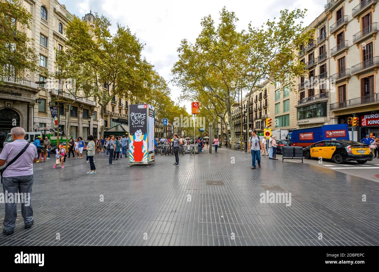 Tourists and local Spaniards enjoy a walk on La Rambla in Barcelona Spain Stock Photo