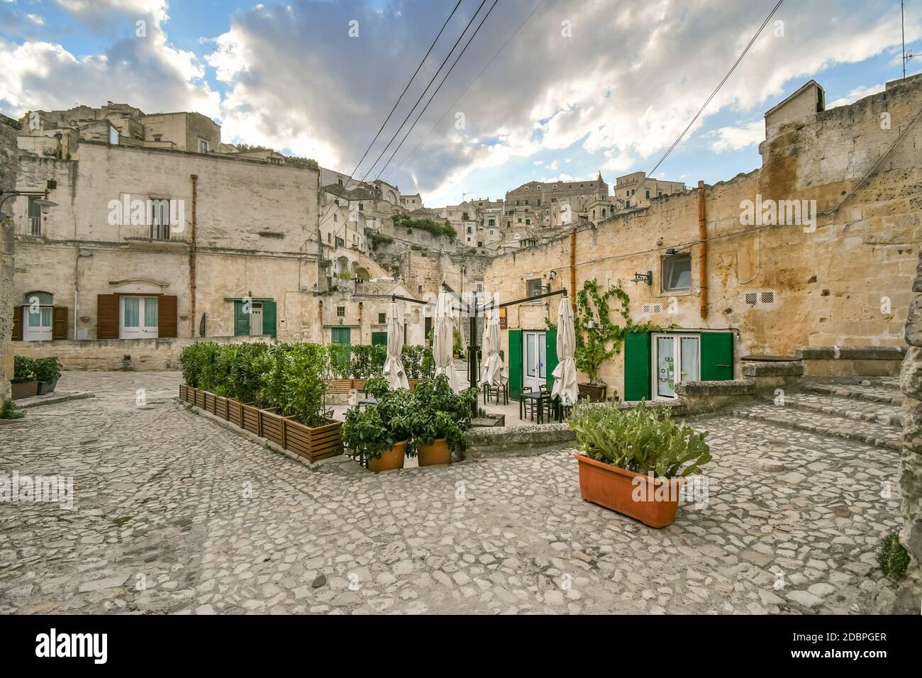 A typical outdoor patio or sidewalk cafe at a restaurant in the historic center of Matera, Italy Stock Photo