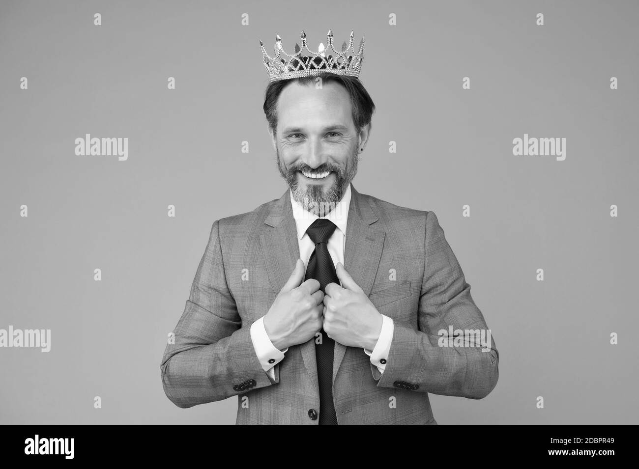 Treating himself as royalty. Big boss grey background. Selfish boss wear luxury crown. Narcissistic boss. Big boss or ceo in formalwear. Ambitious and egoistic. Glory and triumph. Success in business. Stock Photo