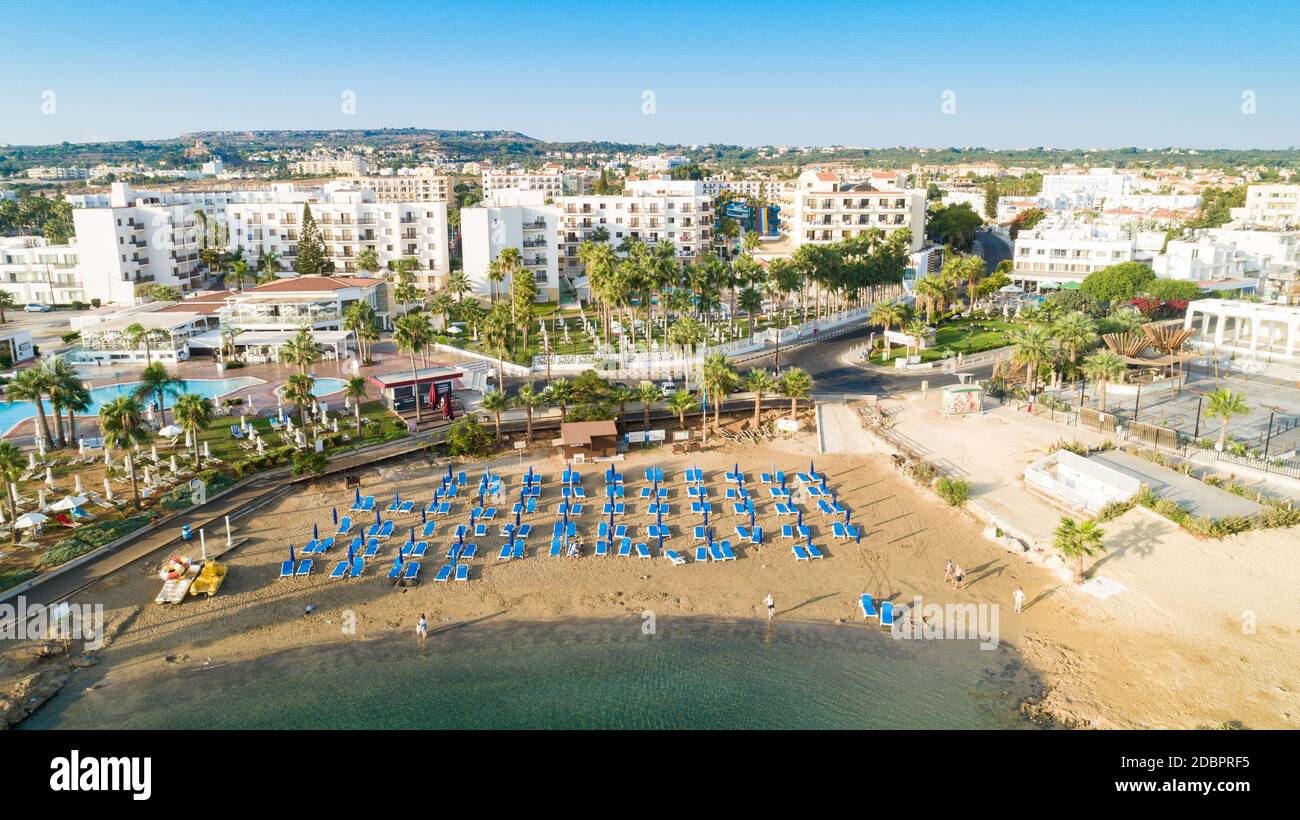 Aerial bird's eye view of Pernera beach in Protaras, Paralimni, Famagusta, Cyprus. The famous tourist attraction golden sandy bay with sunbeds, water Stock Photo