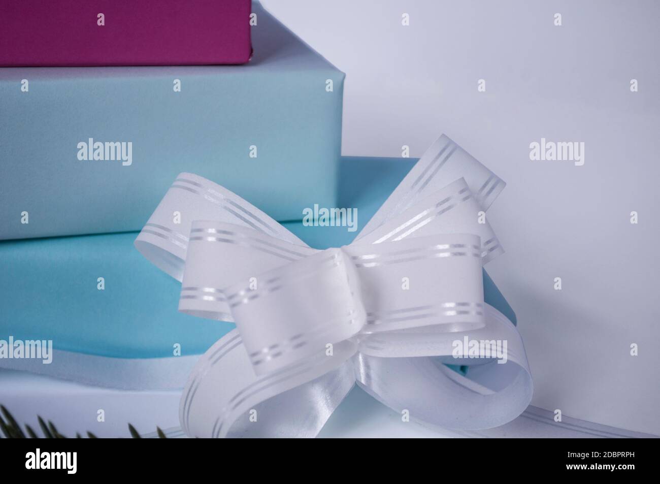 three cardboard gift boxes with a bow on a light background Stock Photo