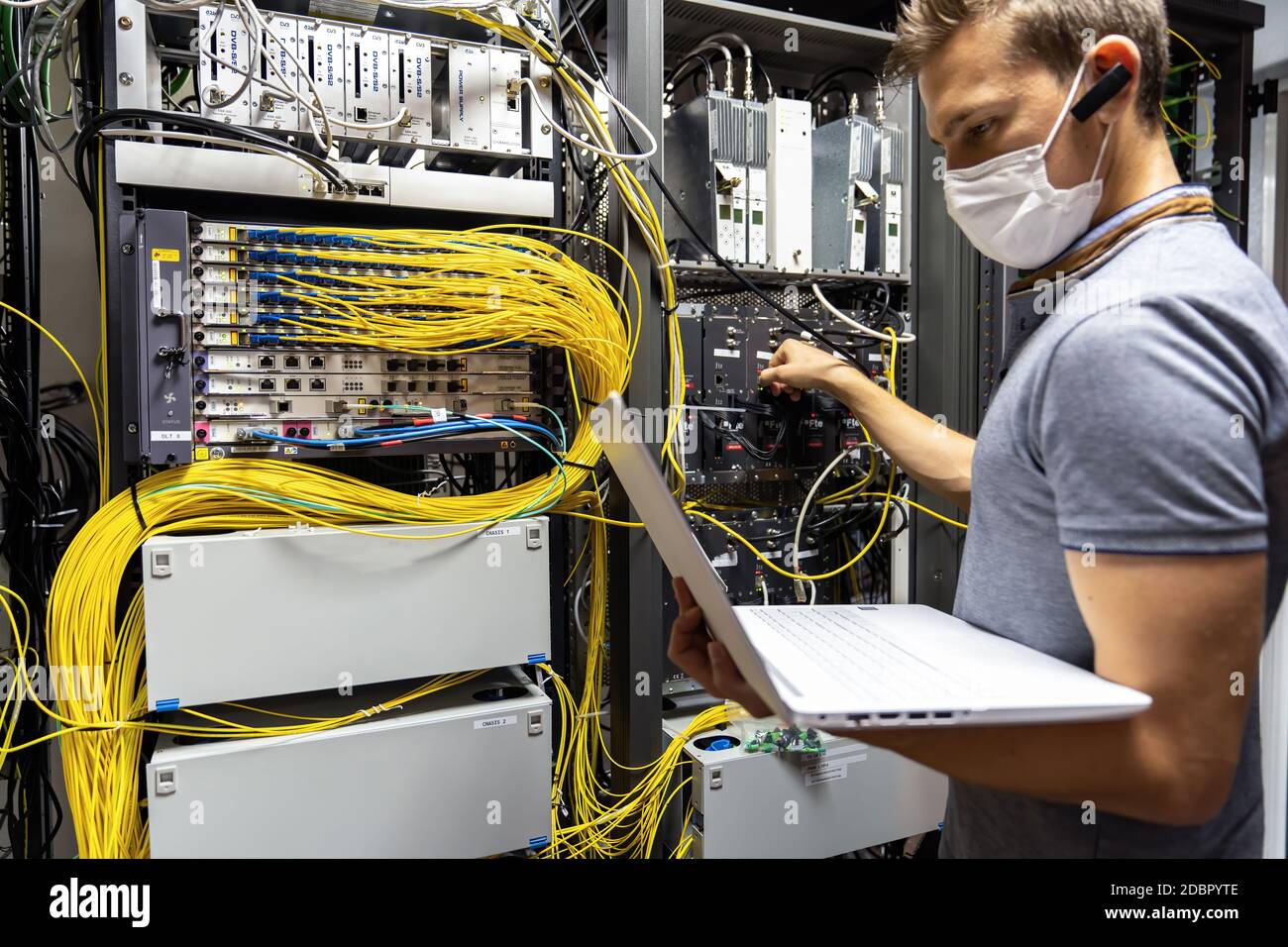 Technician engineer fixing problem with servers and data in cables room Stock Photo