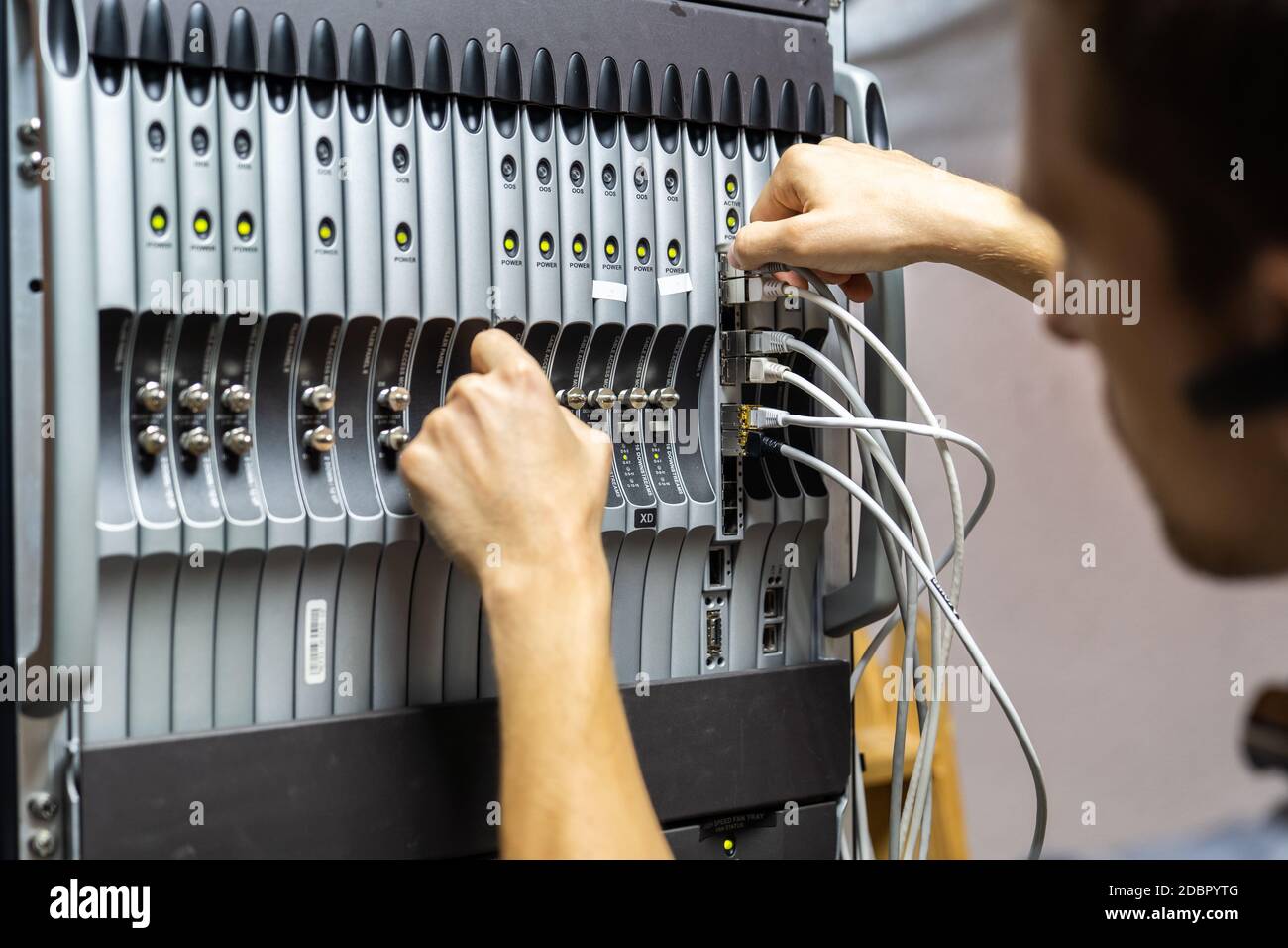 Technician engineer fixing problem with servers and data in cables room Stock Photo