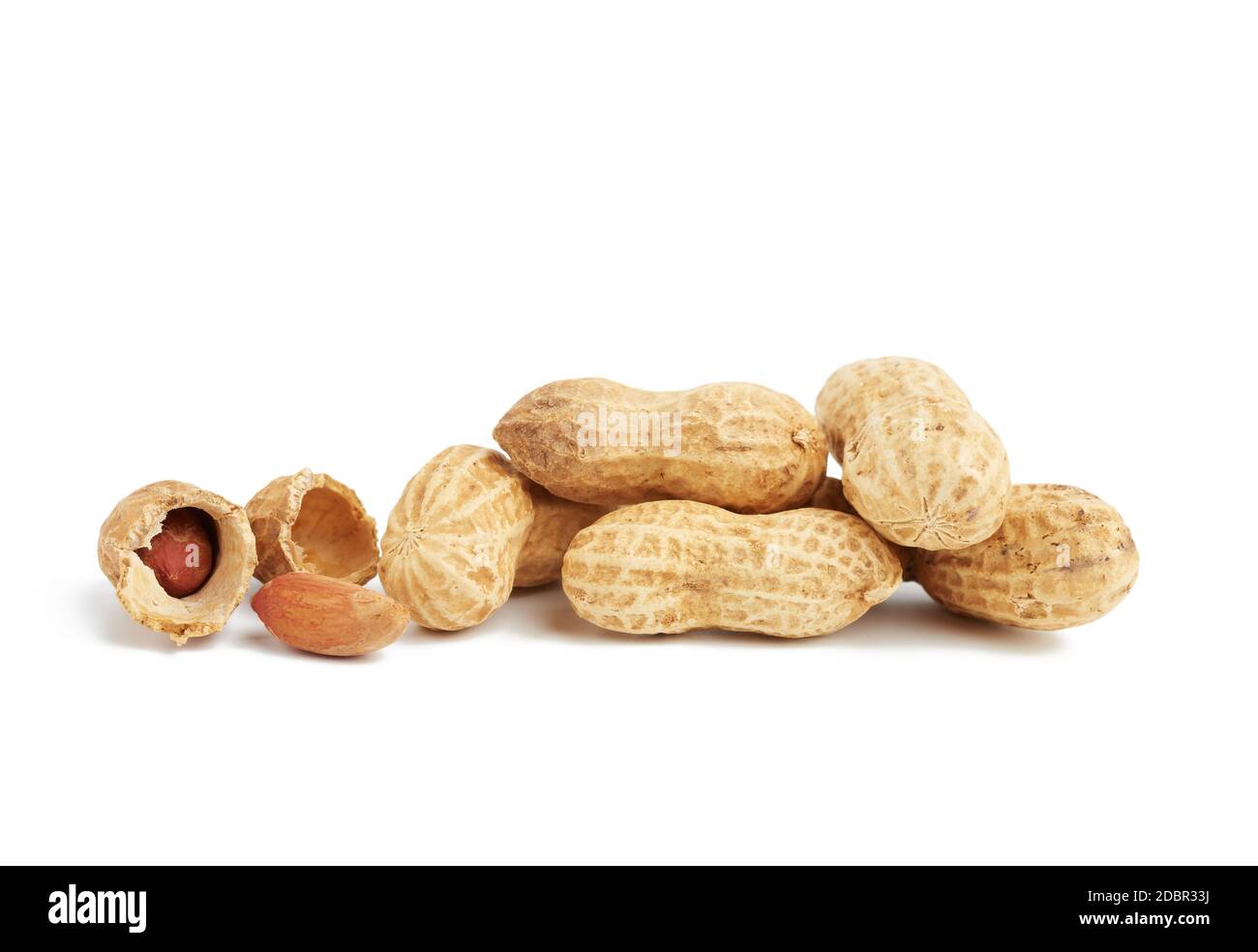 heap of peanuts in shell and broken, food isolated on white background Stock Photo