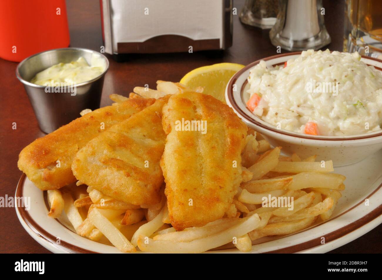 Beer battered fish sticks with french fries and coleslaw Stock Photo
