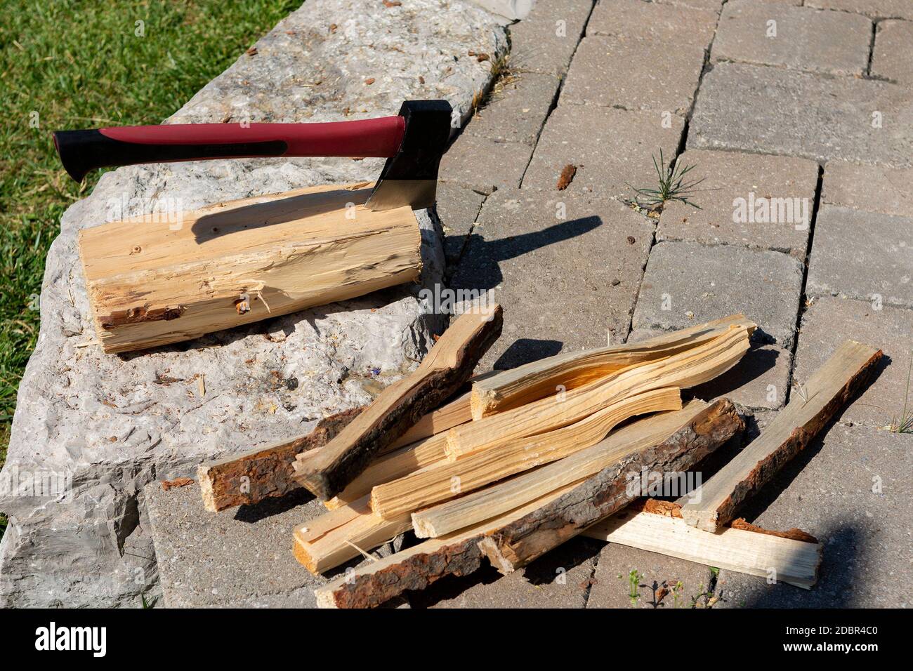 An ax and a pile of chopped firewood for a bonfire Stock Photo