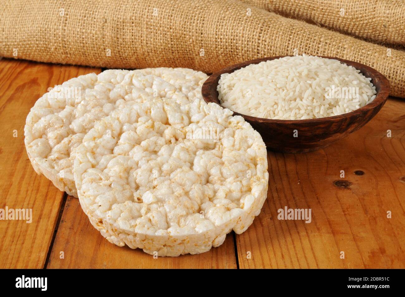 Puffed ricecakes with uncooked long grain white rice Stock Photo