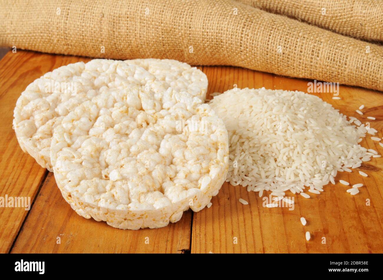 Puffed ricecakes with long grain white rice on a rustic wood table Stock Photo