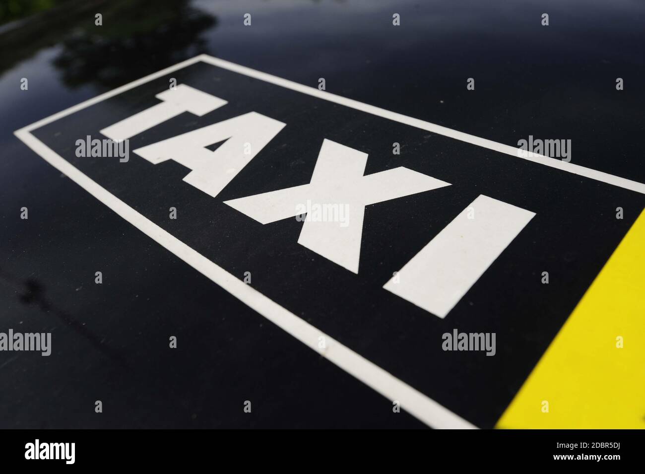 black and white Taxi sign on the hood of a car Stock Photo Alamy
