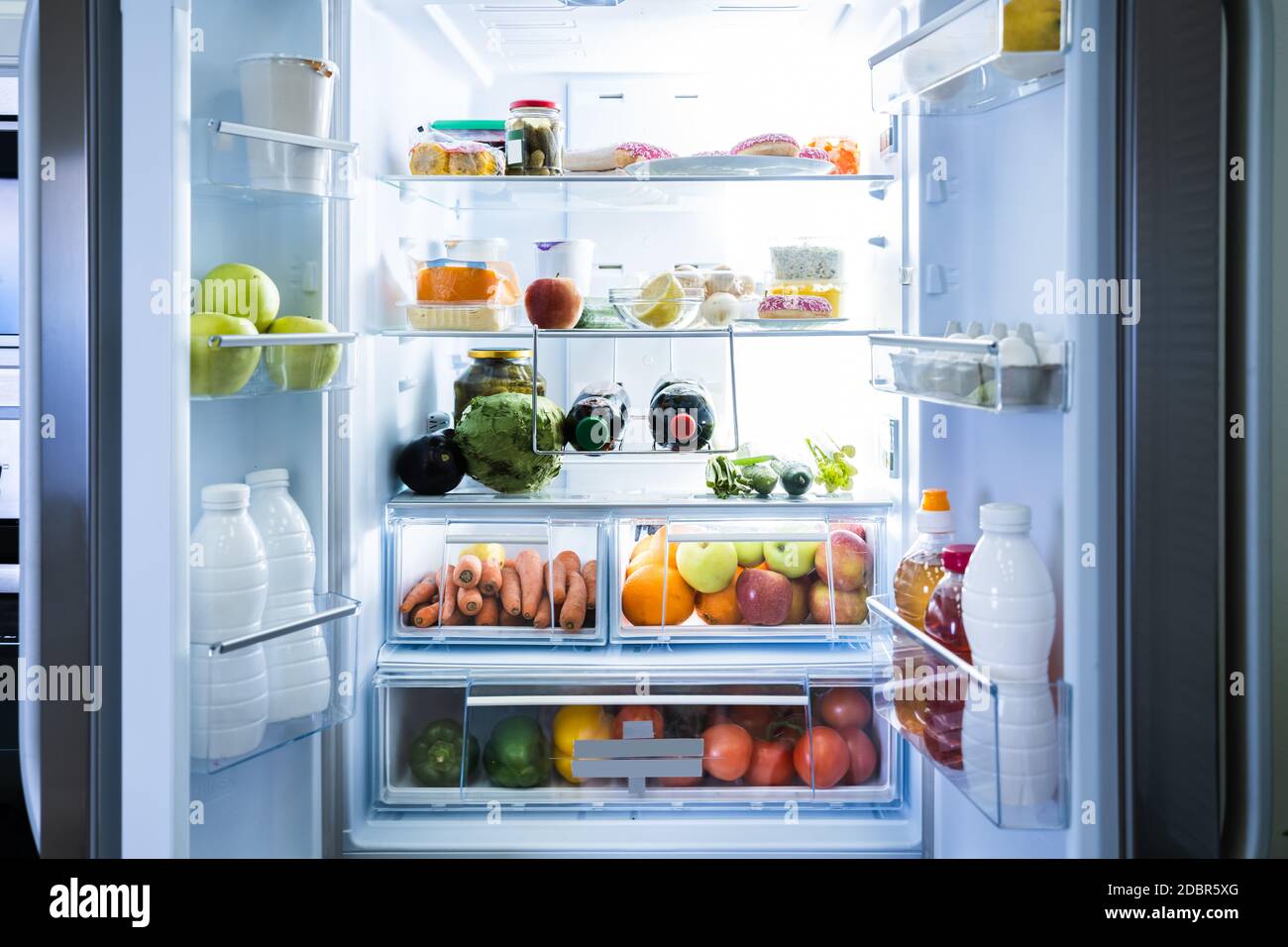 Open Refrigerator Or Fridge Door With Food Inside Stock Photo