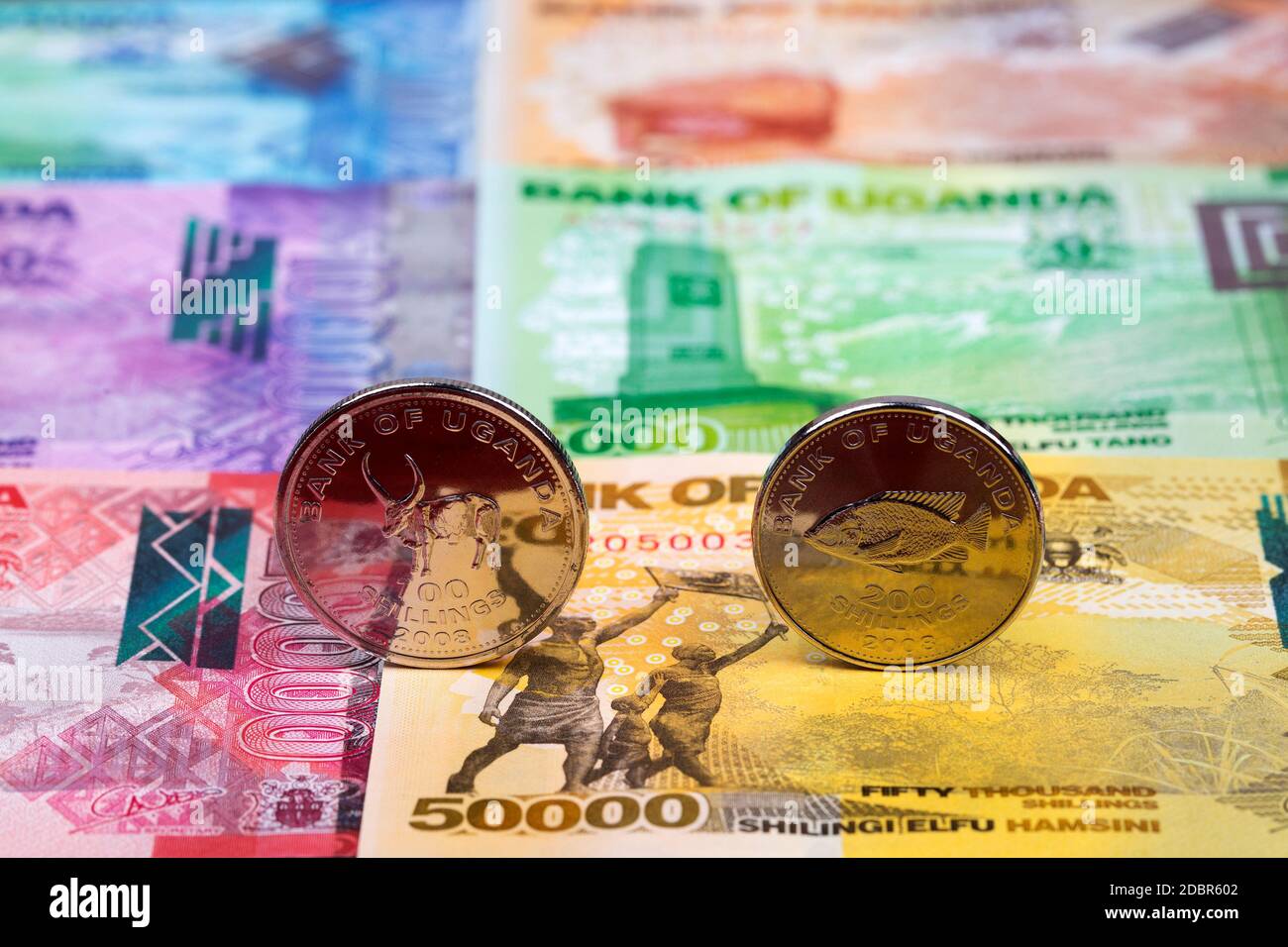 Ugandan coins on the background of money Stock Photo