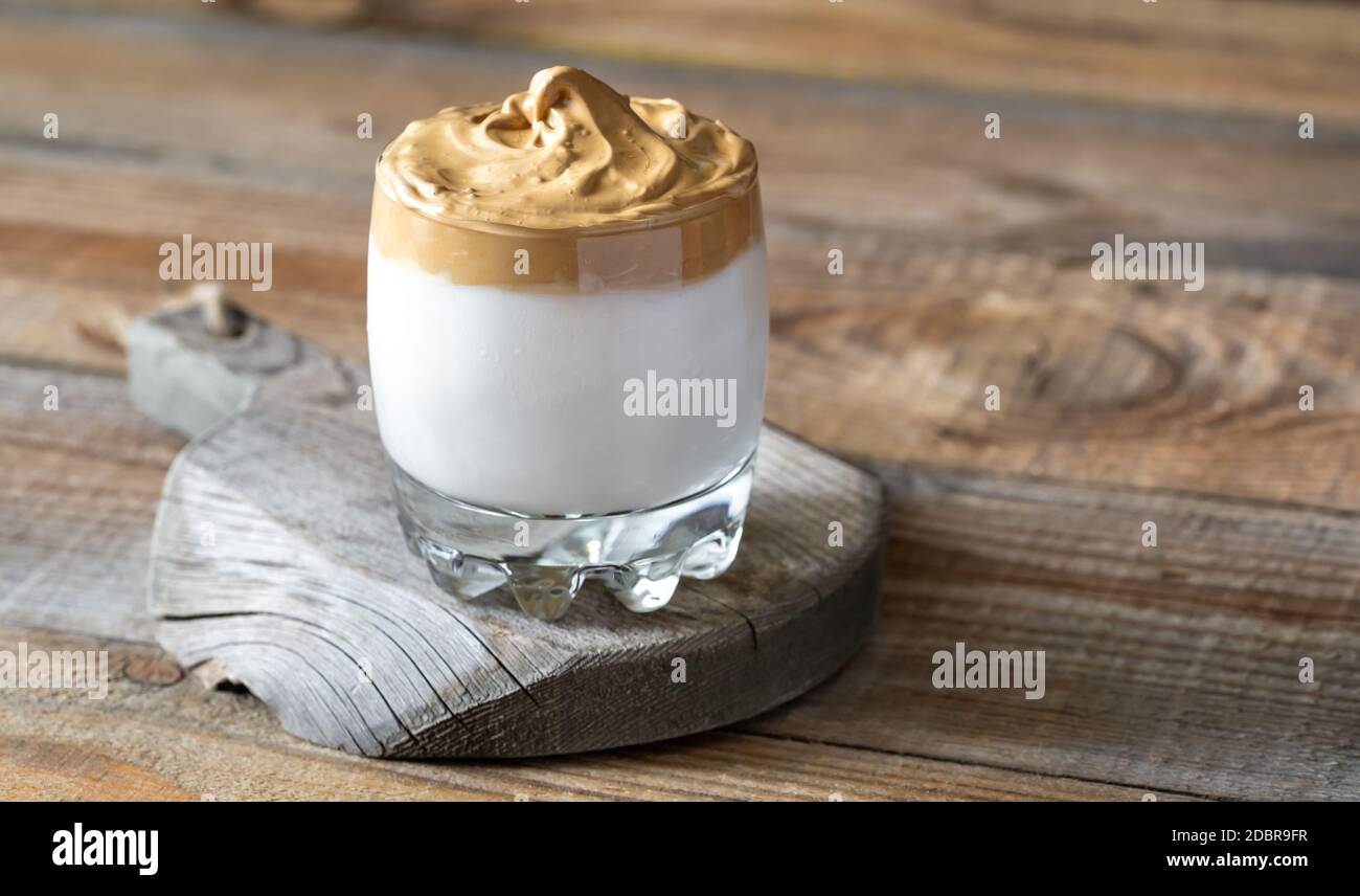 Glass of dalgona coffee on rustic background Stock Photo
