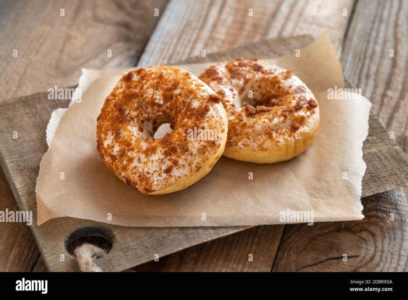 Two donuts on the wooden board Stock Photo