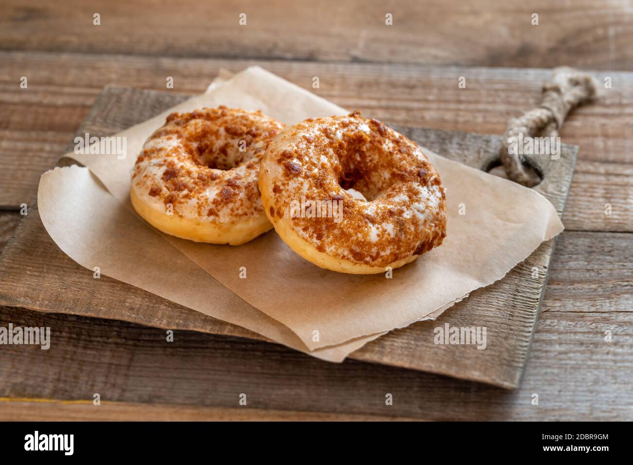 Two donuts on the wooden board Stock Photo