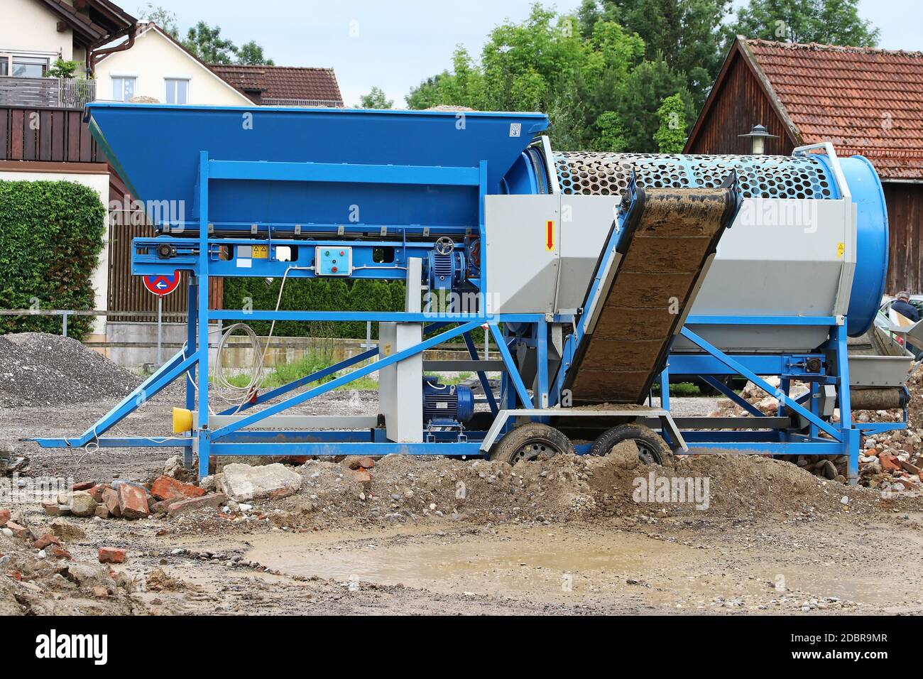 A mobile stone crusher or building rubble shredder for crushing construction material, stones and bricks Stock Photo