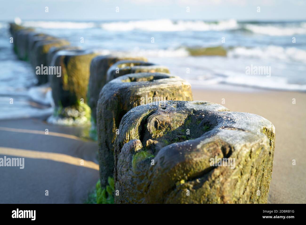Breakwater on the beach of the Baltic Sea near Rewal in Poland Stock Photo