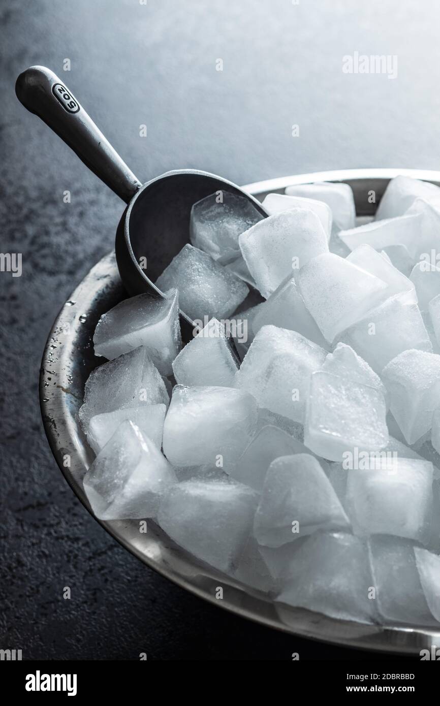 Cold ice cubes in metal bowl. Stock Photo