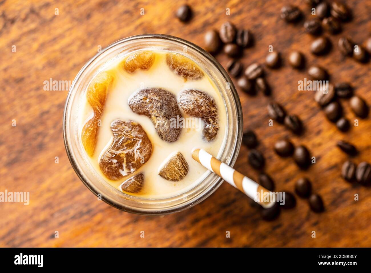 https://c8.alamy.com/comp/2DBRBCY/iced-coffee-with-coffee-ice-cubes-on-wooden-table-top-view-2DBRBCY.jpg