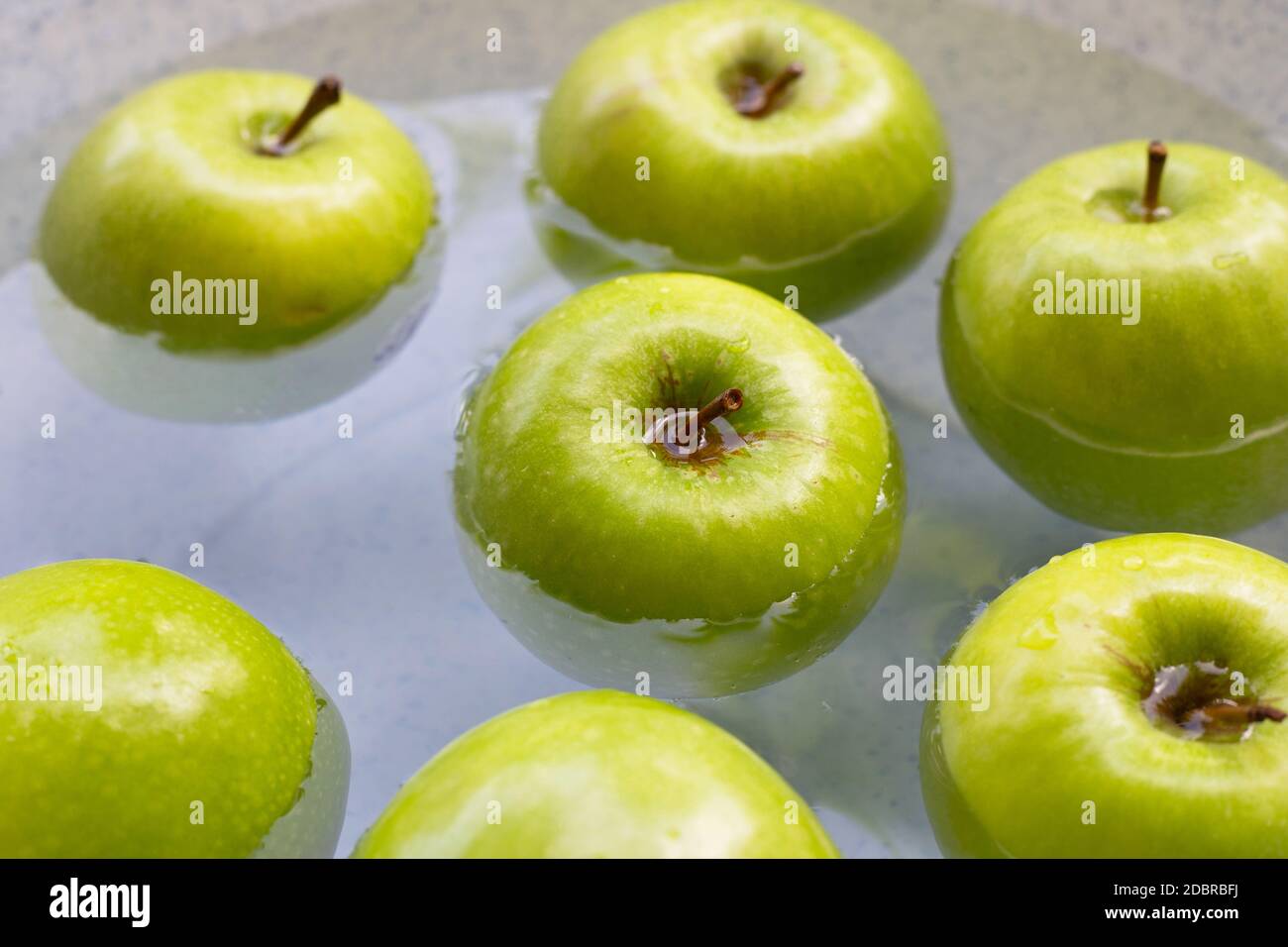 Soak fresh green apples in water. Washing fruit concept Stock Photo Alamy