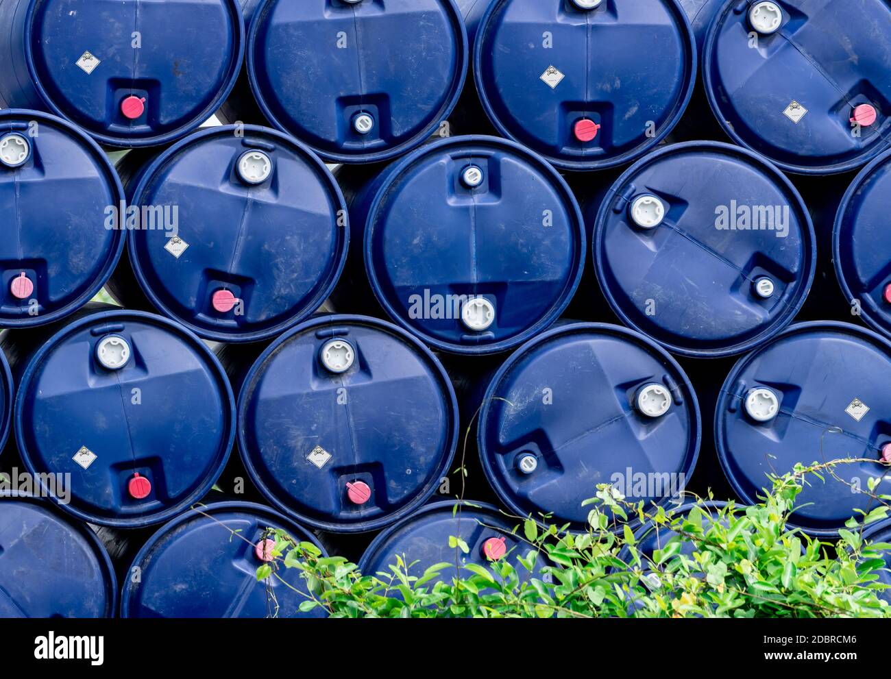 Closeup stack of chemical barrels. Blue oil drum. Plastic oil tank
