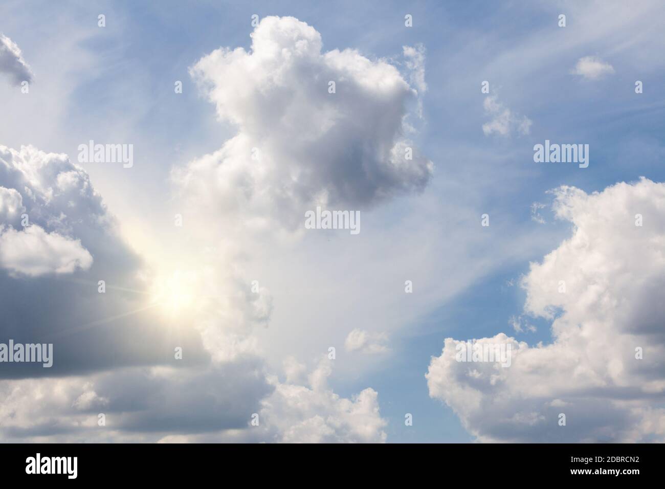 Morning sun light peeking out from a beautiful cloudscape sky. Dramatic ...