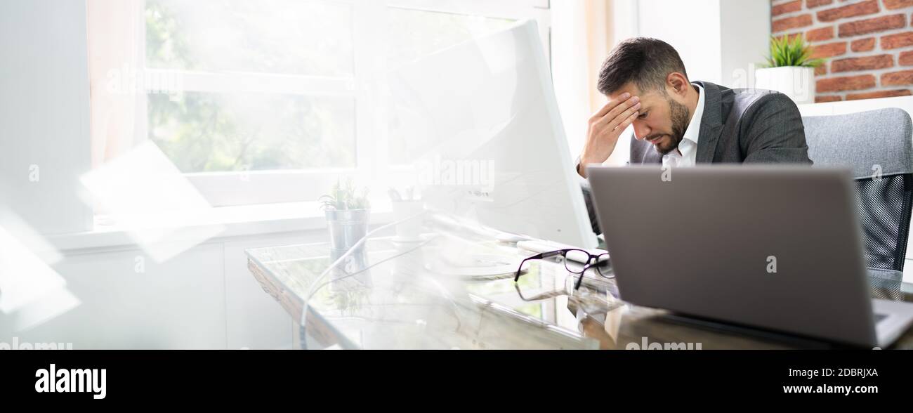 Stressed Man With Migraine And Headache In Front Of Computer Stock ...