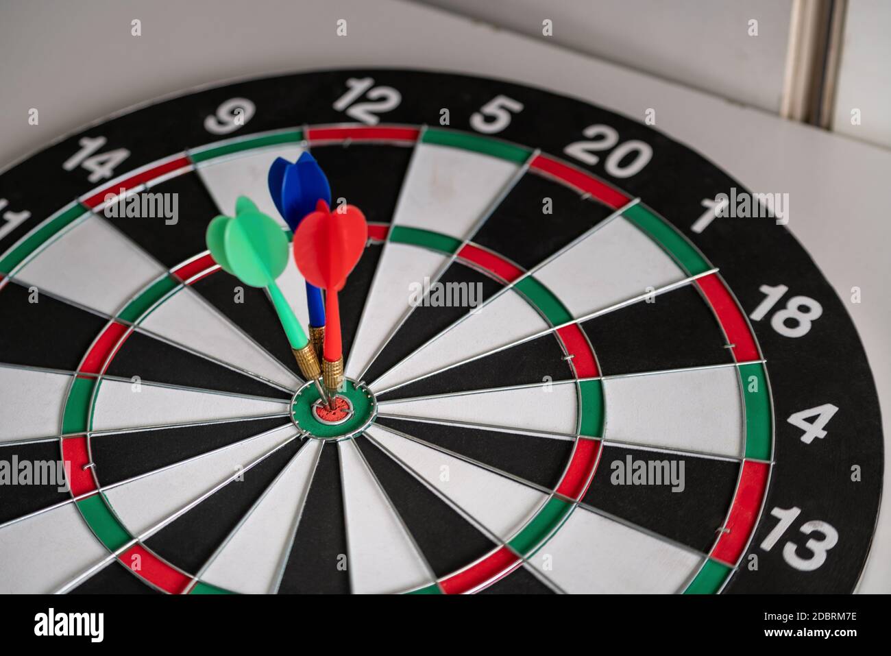 Concept of challenge in business marketing bullseye and intelligent customer reaching. The dart is the strategy or skill. The dartboard is the target Stock Photo