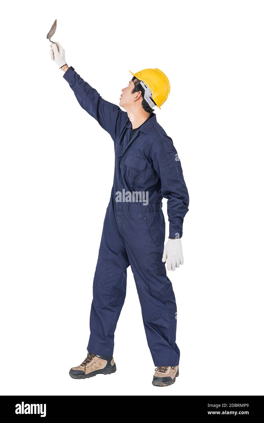 Portrait of a workman with blue coveralls and hardhat in a uniform holding steel trowel on white background with clipping path Stock Photo