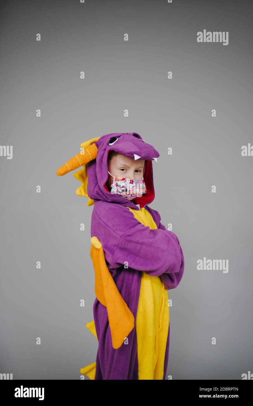 beautiful young girl with nose and mouth mask and dragon costume Stock Photo