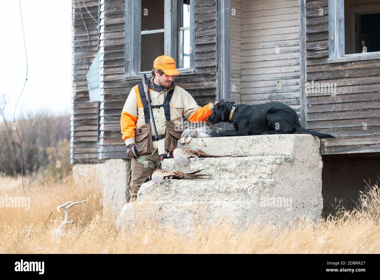 A pheasant hunter and his retriever after a successful day Stock Photo