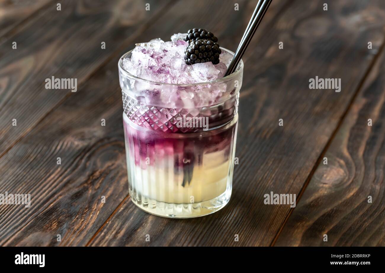 Glass of Bramble cocktail made of gin, lemon juice, sugar sypup and