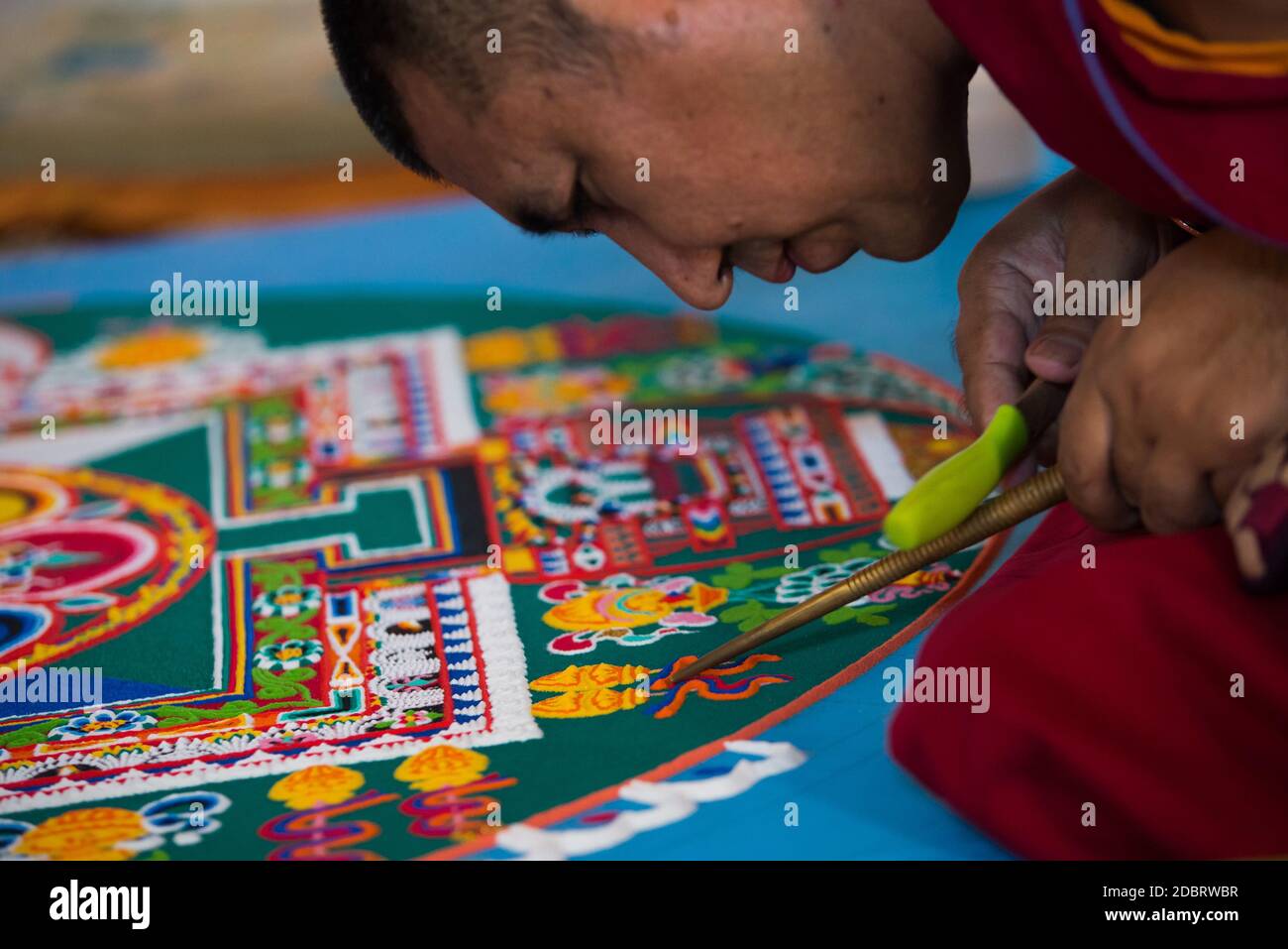Auroville, India - February 2019: 4 Monks of the Tashi Lumpo Monastery in Tibet creating the Mandala of Compassion in Auroville. Stock Photo