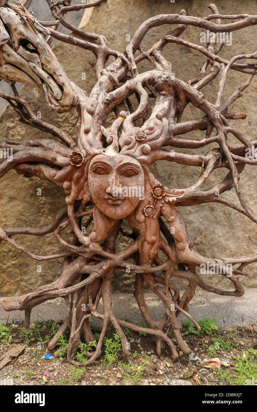 Sun with face made of tree root. Wooden decoration. Dried fibrous roots that spread beautifully to the soil surface. can be used as a background templ Stock Photo
