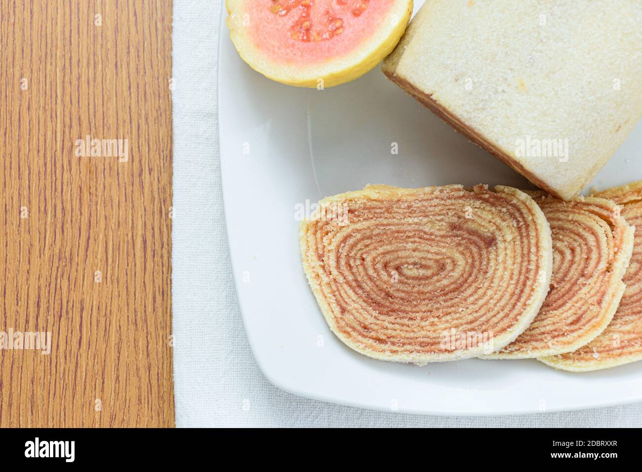 Bolo de rolo (roll cake) next to guavas. Traditional Brazilian sweet top  view Stock Photo - Alamy