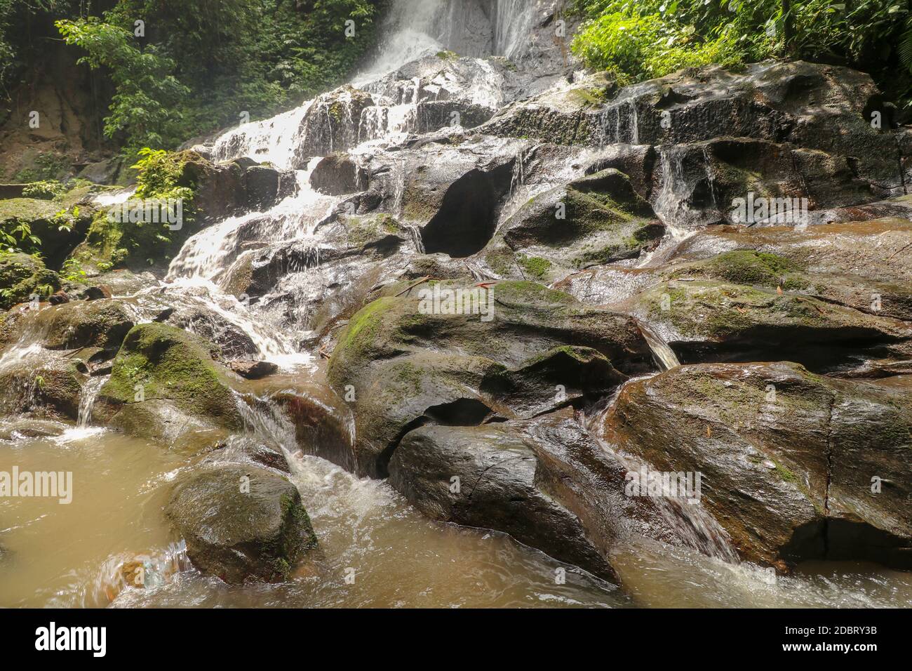 Scenic cascade Goa Giri Campuhan waterfall in tropical jungle in Bali, Indonesia. Amazing and beautiful hidden Waterfall in Paradise. Stock Photo