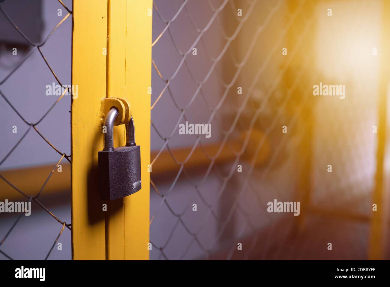 Closed padlock on the gate side view. copyspace Stock Photo