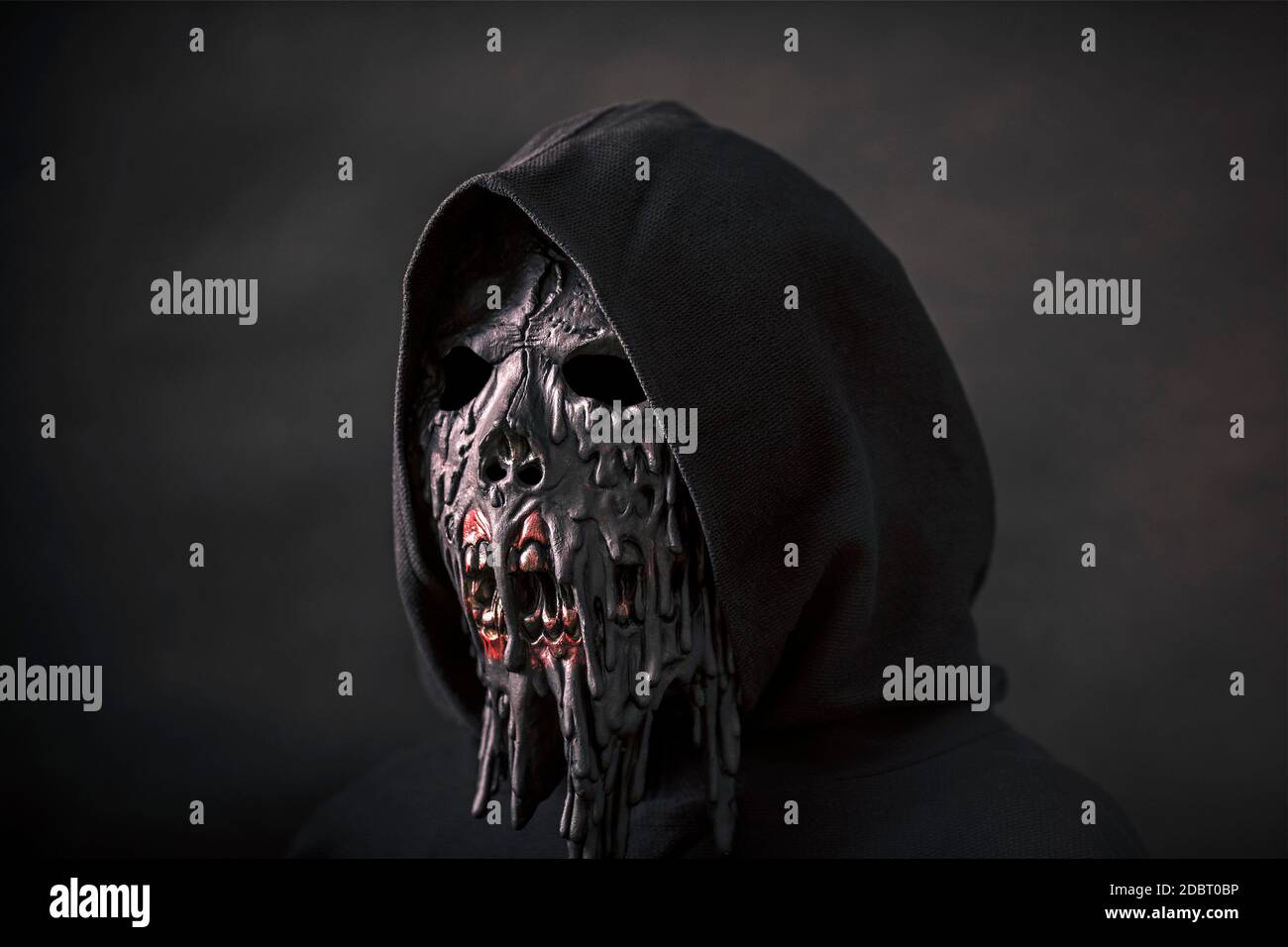 Scary figure in hooded cloak with mask Stock Photo