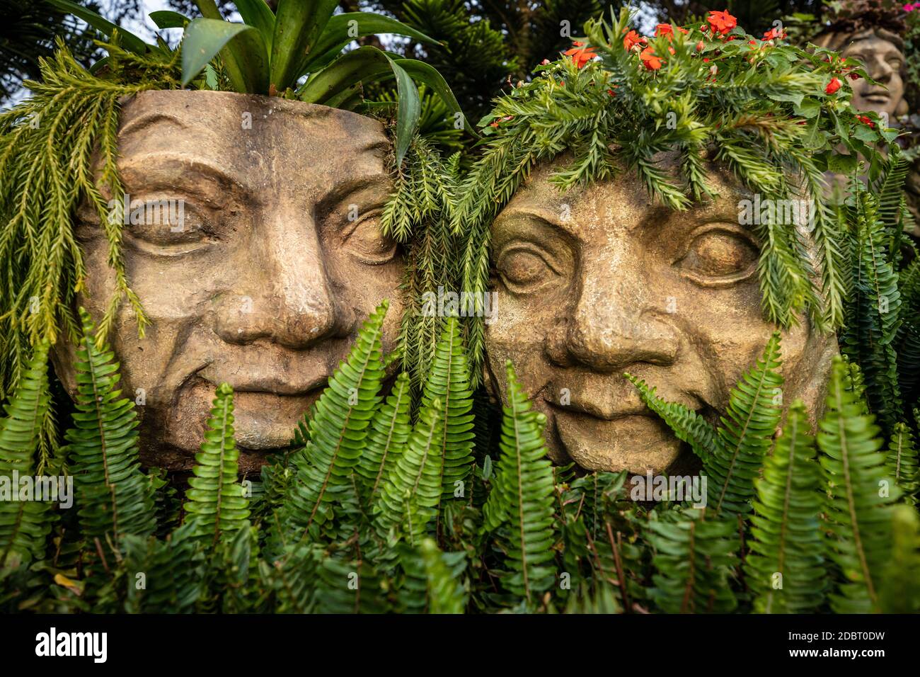statue of faces in the garden Stock Photo Alamy