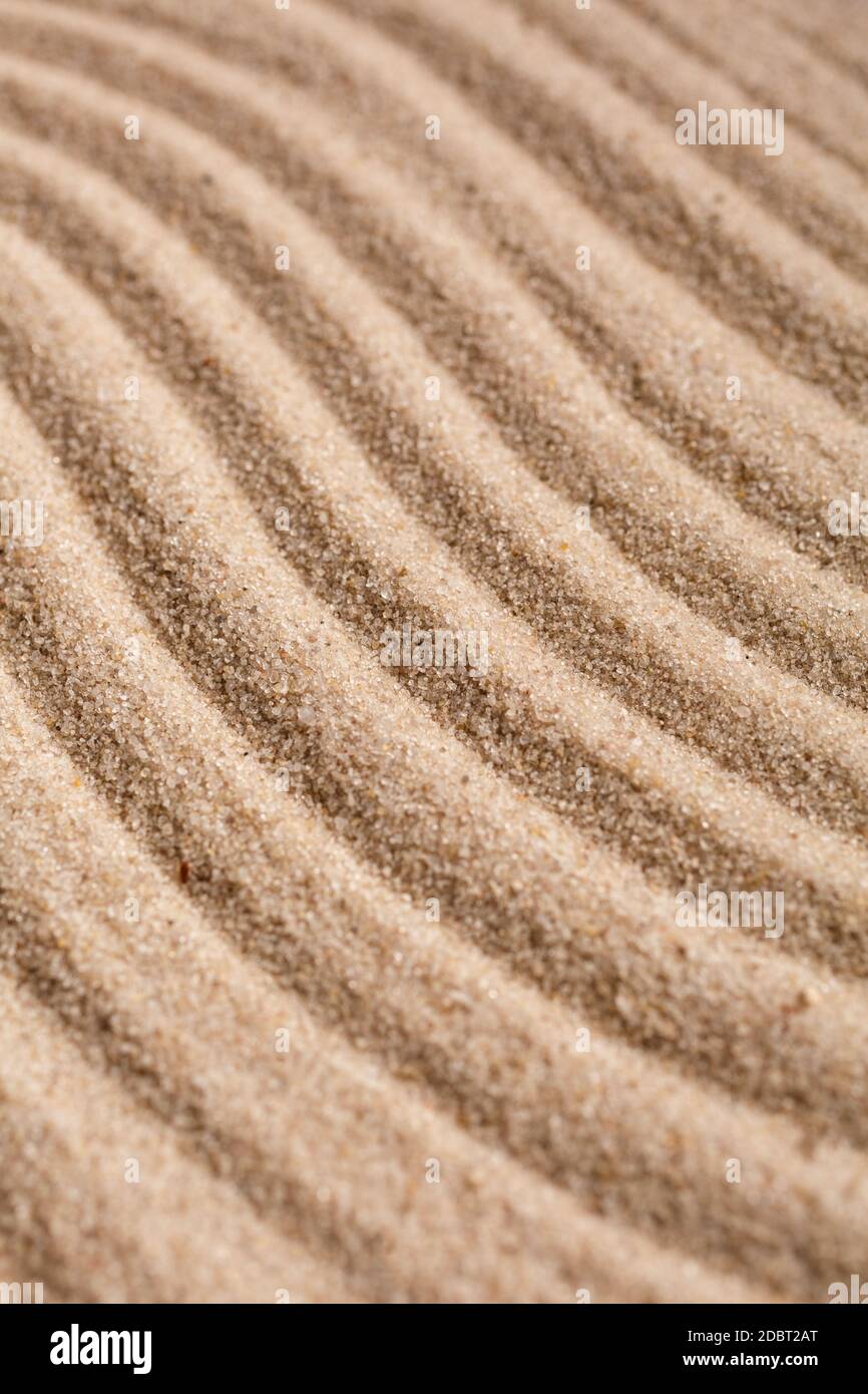 Sand Texture. Brown sand. Background from fine sand. Sand background. Waves texture. Stock Photo