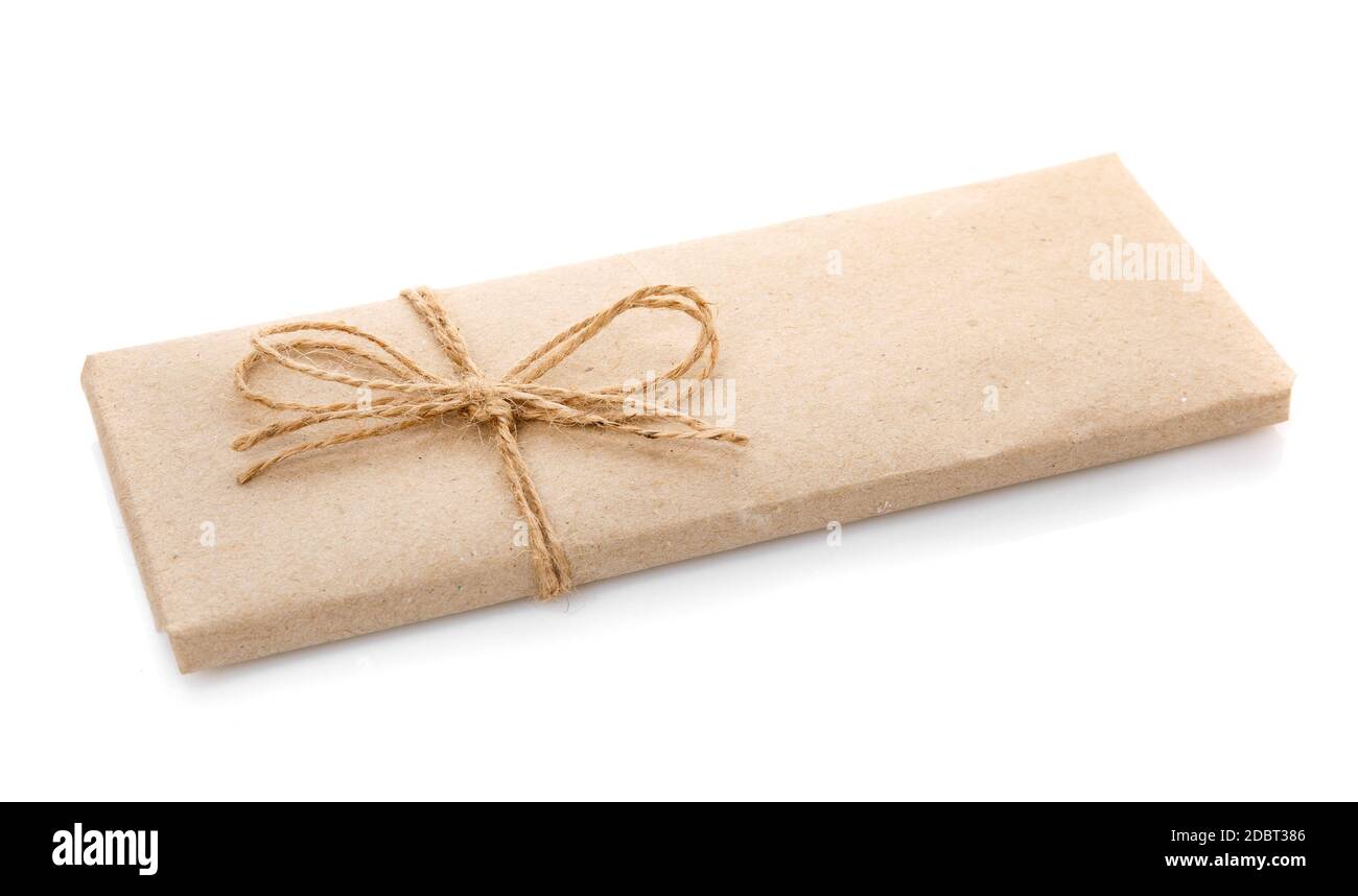Box wrapped in kraft paper and with burlap ribbon on a white background ...